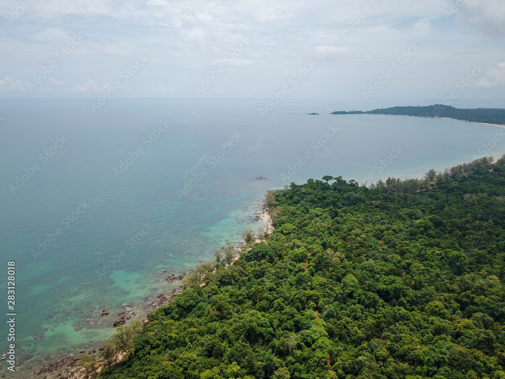 Aerial view of tropical island jungle with palms and emerald clear water. Phu Quoc, Vietnam.