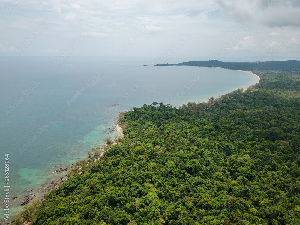 Aerial view of tropical island jungle with palms and emerald clear water. Phu Quoc, Vietnam.