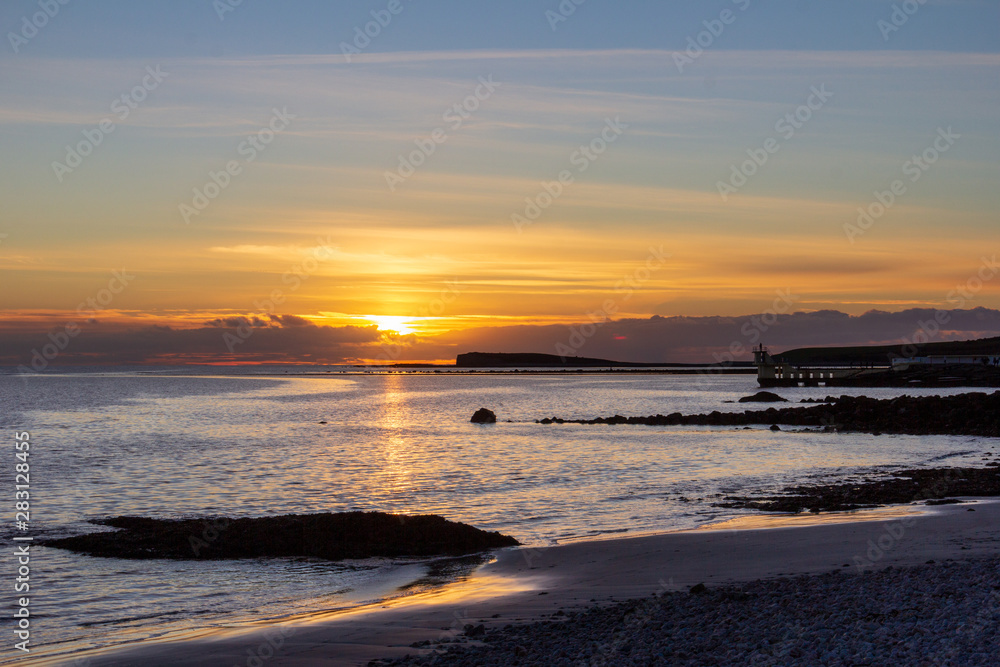 A viewpoint over the water at Salthill, Galway, Ireland is a popular place to watch the sunset on the Irish coast