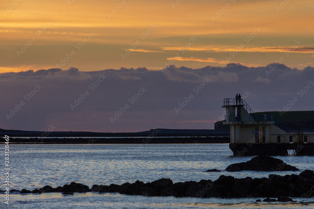 A viewpoint over the water at Salthill, Galway, Ireland is a popular place to watch the sunset on the Irish coast
