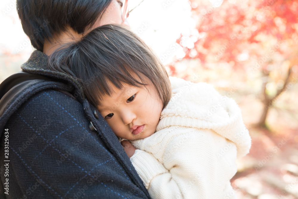 Daughter hugged by mother