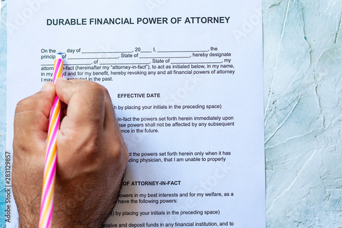 Fotografie Filling durable financial Power of Attorney Form or POA document