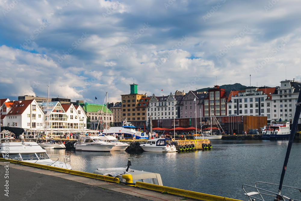 Scenic summer view with the Old Town pier architecture and boats in Bryggen - Hanseatic wharf, Bergen, Norway.