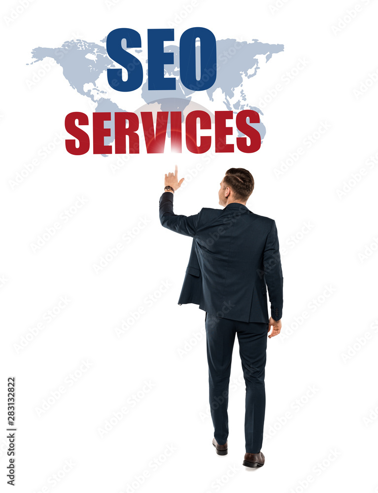 back view of man pointing with finger at seo services lettering while standing isolated on white back view of man pointing with finger at seo services lettering while standing isolated on white