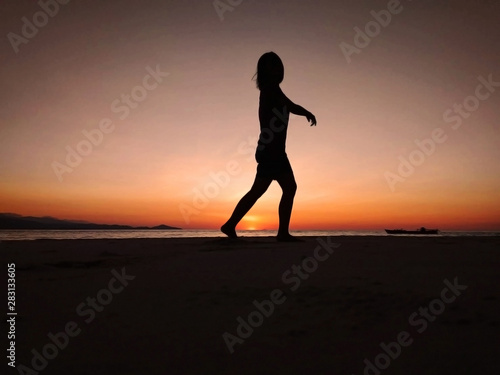 the silhouette of a women at the sunset