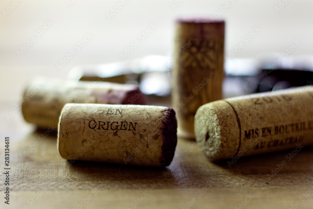 close up corks and corkscrew over wooden table