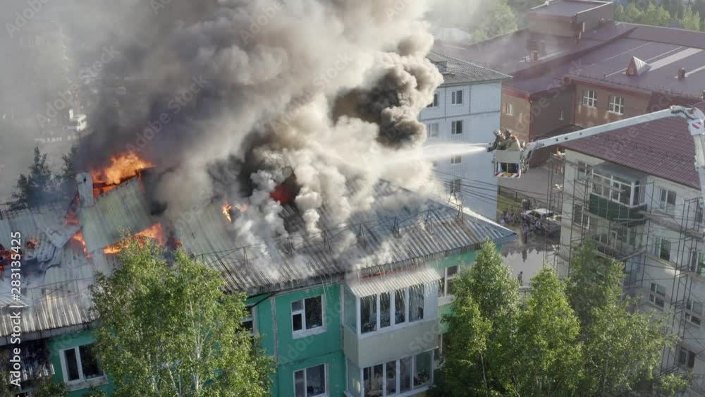 firefighters extinguish a fire on the roof of a residential highrise building. top view firefighters extinguish a fire on the roof of a residential highrise building. top view