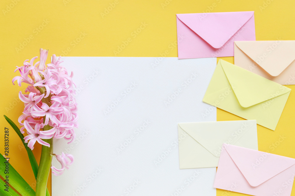 Colorful envelopes and hyacinth flowers on yellow background Colorful envelopes and hyacinth flowers on yellow background