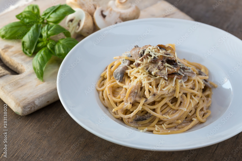 Mushroom Spaghetti Pasta and cream sauce on table, top view. Homemade italian pasta with champignon mushroom