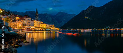 Sunset panoramic view of Kotor Bay and the lights in the postcard perfect town of Perast, Montenegro, long exposure photo