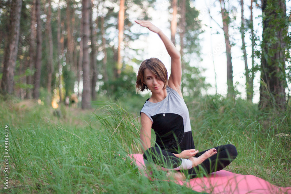 Woman practicing yoga alone in the park outdoor Woman practicing yoga alone in the park outdoor