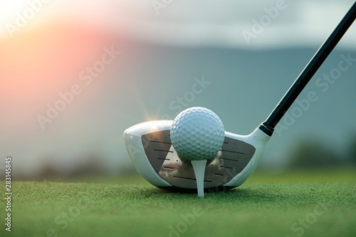 Golf ball and golf club in beautiful golf course at sunset background. Golf ball on green in golf course at Thailand