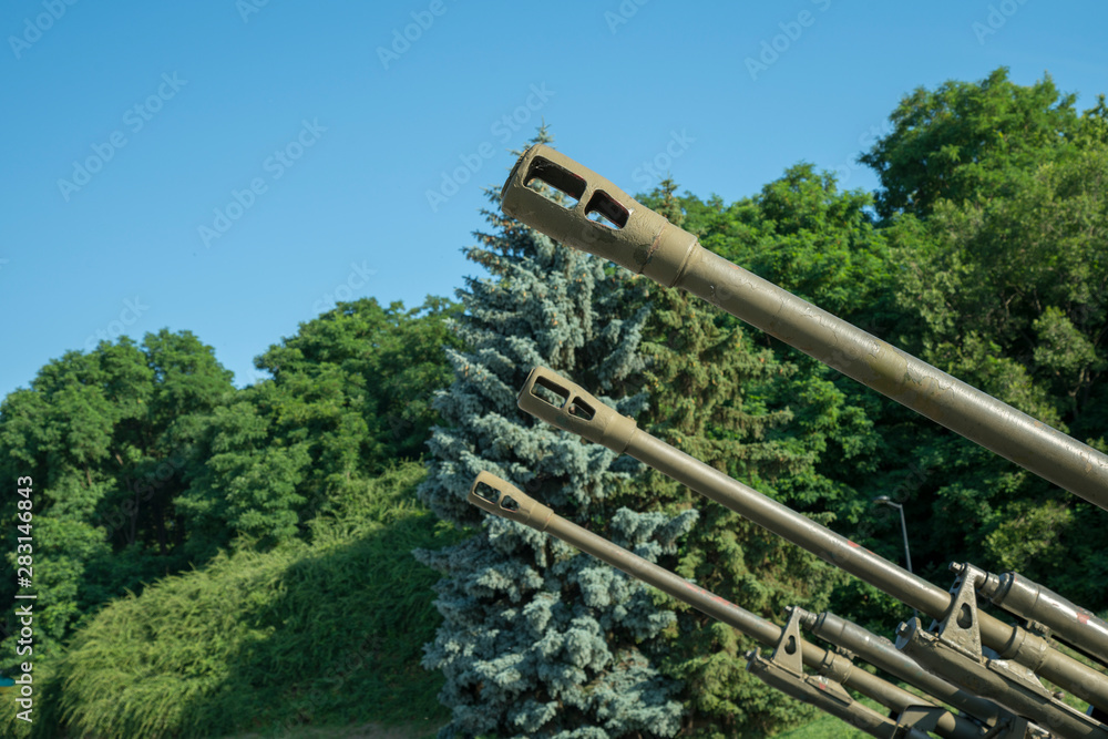 Barrels of artillery against a blue sky. The concept of war and violence Barrels of artillery against a blue sky. The concept of war and violence