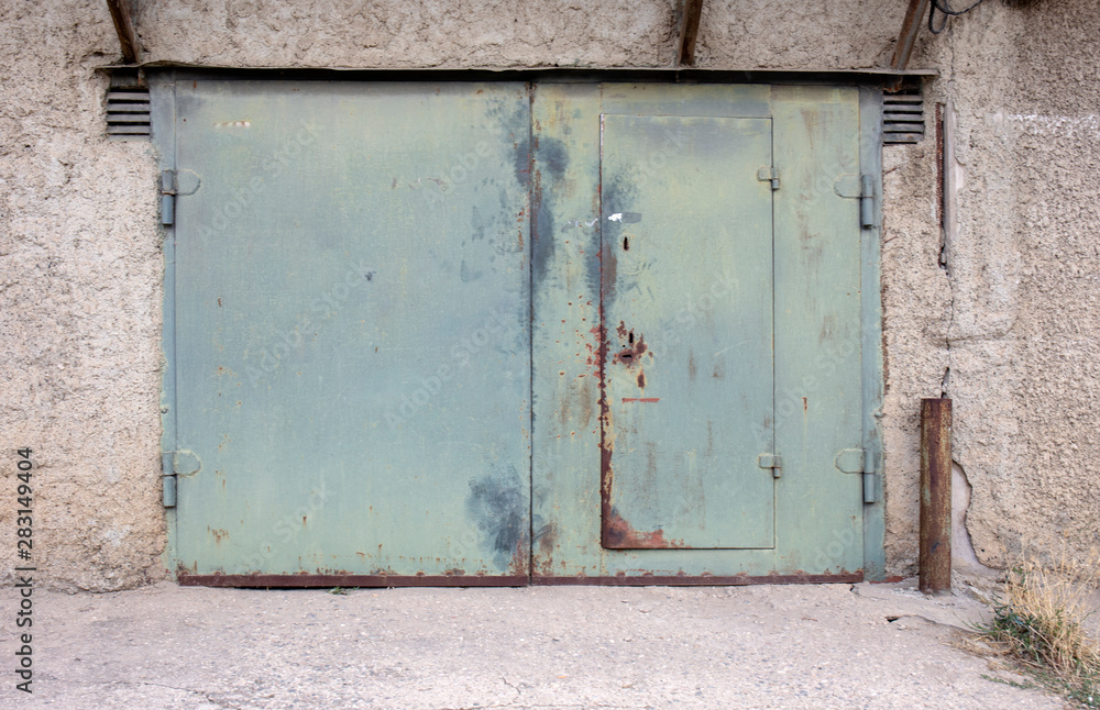 old metal door to the car garage