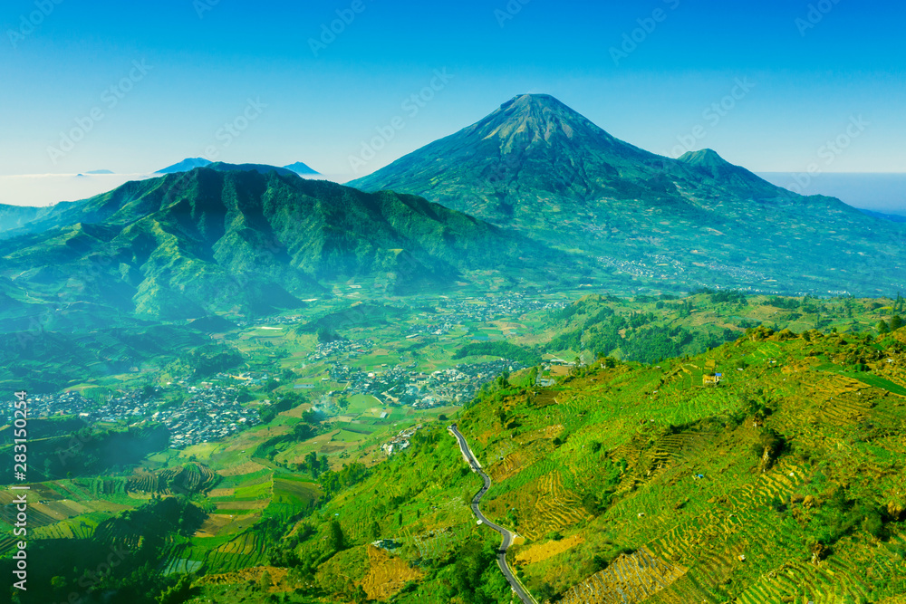 Fototapeta premium Village in Dieng Plateau with Mount Sindoro