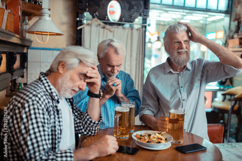 Three pensioners feeling dissatisfied after watching football