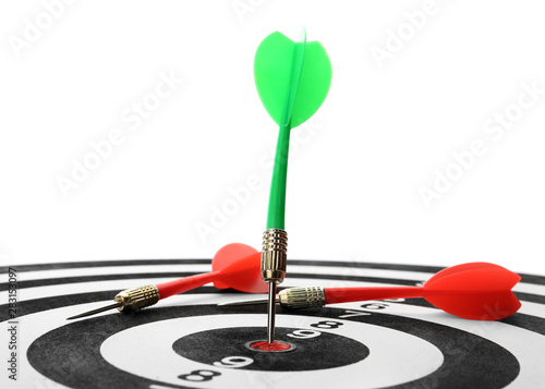 Arrow hitting target on dart board against white background