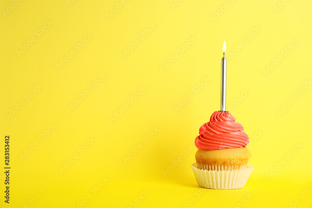 Birthday cupcake with candle on yellow background, space for text Birthday cupcake with candle on yellow background, space for text