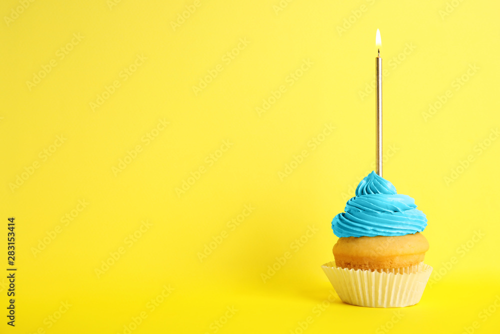 Birthday cupcake with candle on yellow background, space for text Birthday cupcake with candle on yellow background, space for text