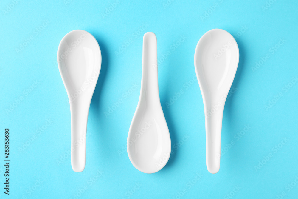 Miso soup spoons on blue background, flat lay Miso soup spoons on blue background, flat lay