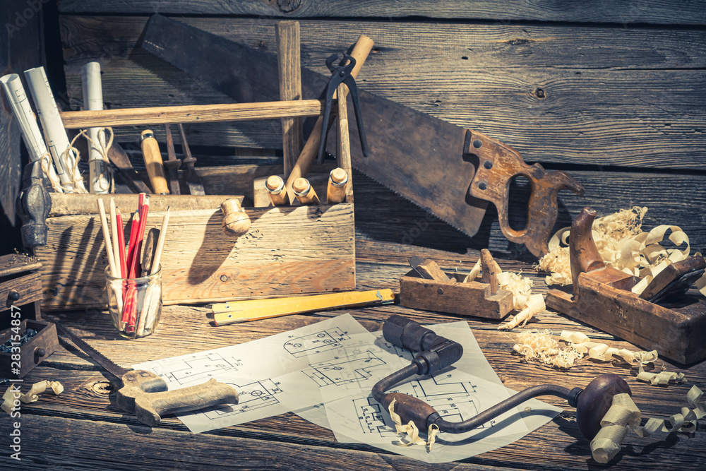 Drawing desk in carpenter workshop on rustic wooden table Drawing desk in carpenter workshop on rustic wooden table