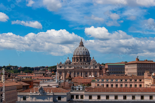 Beautiful aerial view on the St. Peter's Basilica ( Famous Roman landmark ) and ancient classical buildings of the Vatican on background of clouds. City of Rome. Italy. Europe