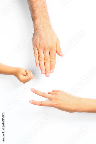 Family playing rock, paper and scissors on white background, closeup