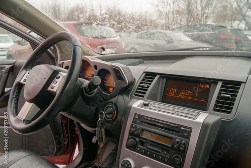 Interior of a japanese car. Steering wheel of a off-road auto car. Hi-fi system and car radio.