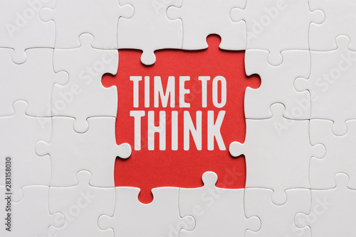 top view of connected jigsaw puzzle pieces near time to think letters