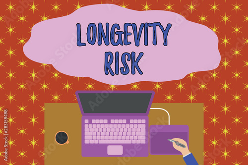 Text sign showing Longevity Risk. Business photo showcasing Potential threat due to increasing lifespan of pensioners Upper view laptop wooden desk worker drawing tablet coffee cup office photo