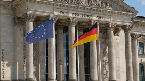 The flag of Germany and the European Union at the Reichstag building in Berlin, Germany