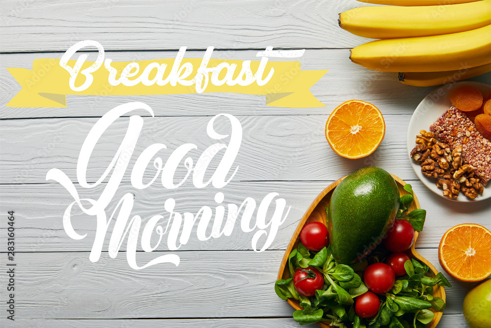 top view of fresh fruits, vegetables in heart-shaped bowl on wooden white background with breakfast, good morning lettering
