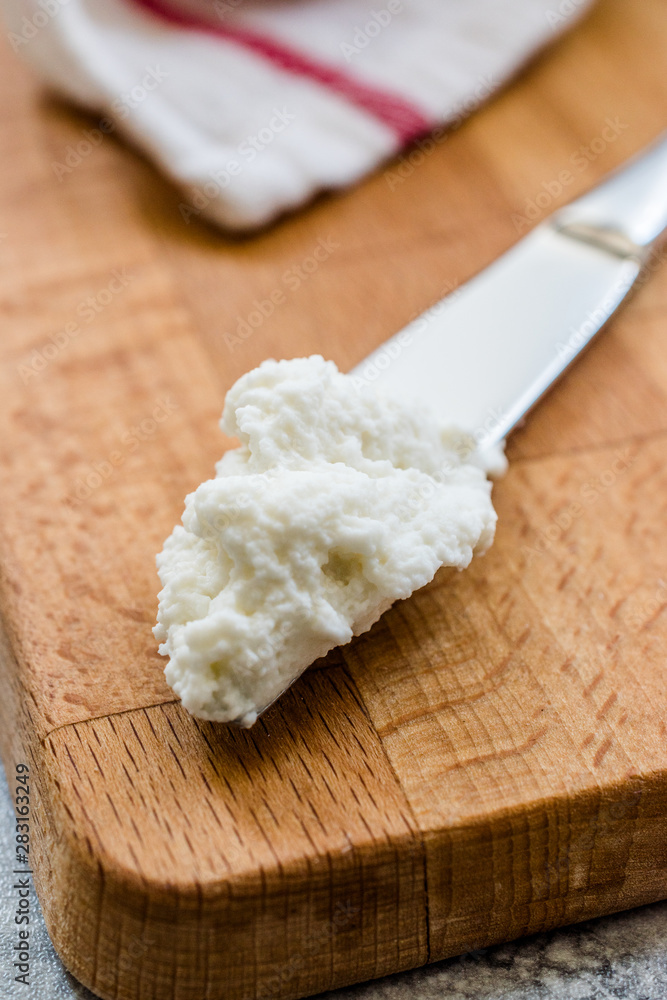 Ricotta Cheese with Knife on Wooden Board Ready to Eat. Ricotta Cheese with Knife on Wooden Board Ready to Eat.