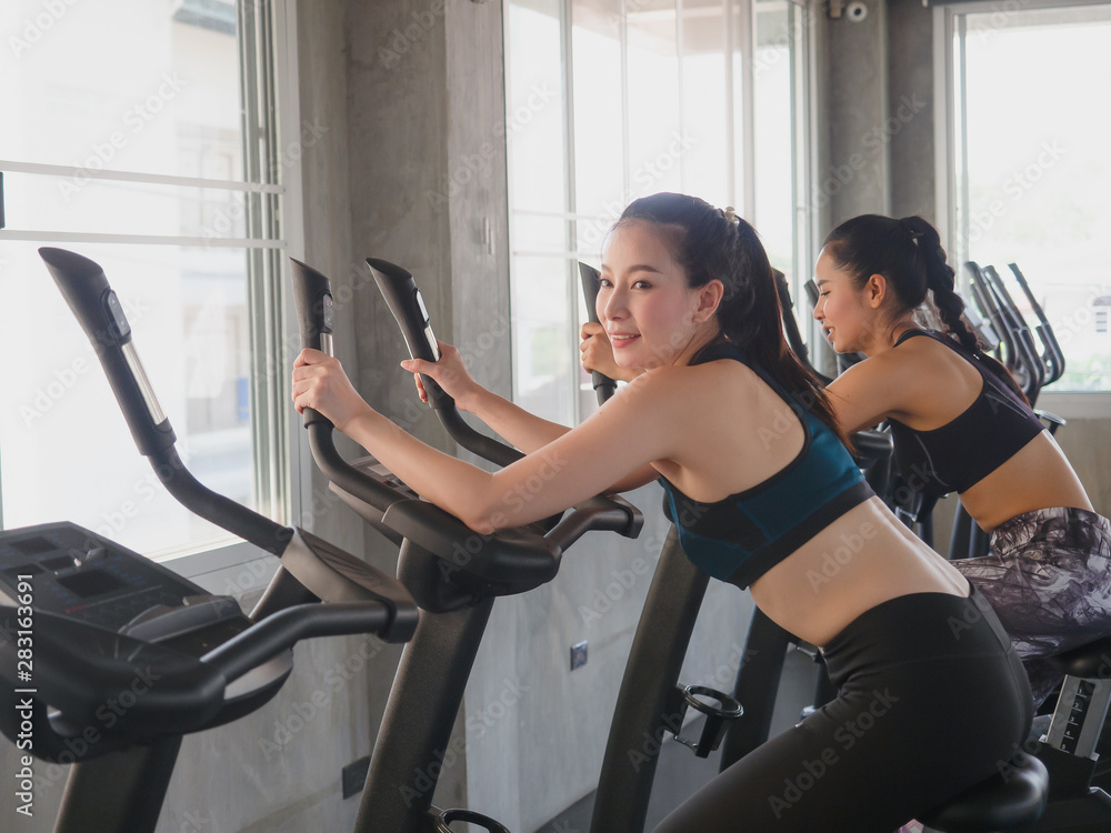 woman exercising their legs doing cardio training and smile woman exercising their legs doing cardio training and smile