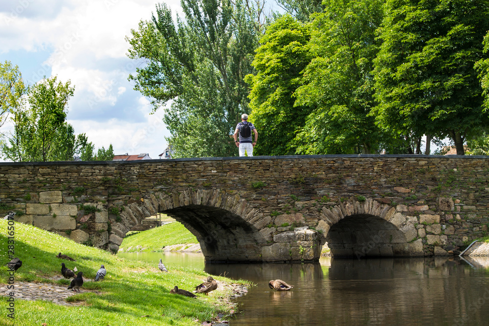 tourist on the bridge watching the river tourist on the bridge watching the river