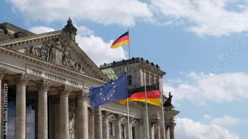 German flags and of flag of the European Union at the Reichstag building in Berlin, Germany
