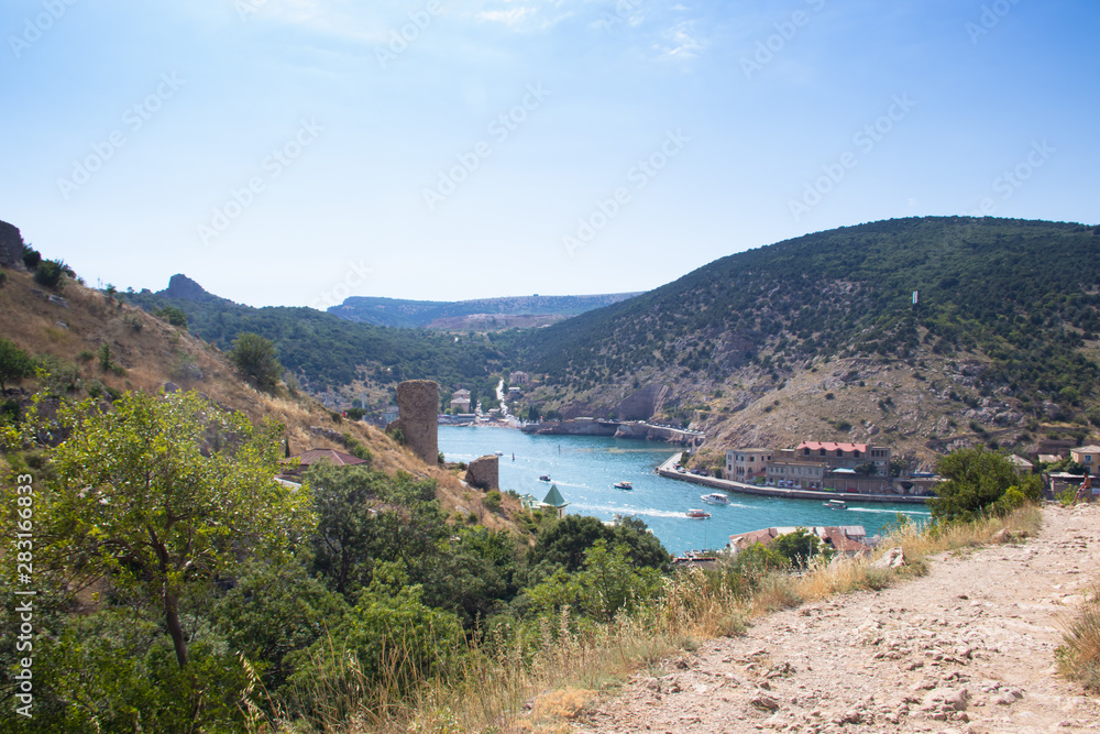 Fototapeta premium Balaklava bay in summer in sunny weather. Crimea, Russia. A lot of boats and ships. Bay for boats.