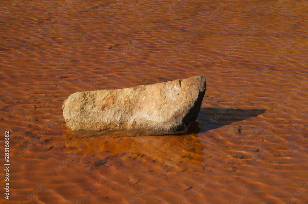 Reddish water from an abandoned copper mine central stone Reddish water from an abandoned copper mine central stone