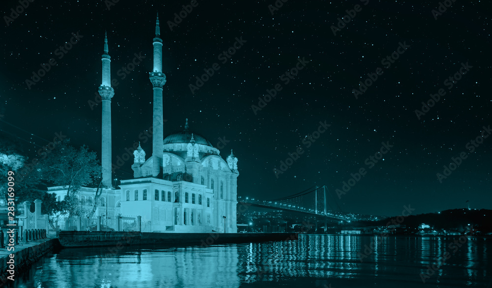 Ortakoy mosque and Bosphorus bridge with lot of stras at night - Istanbul, Turkey 