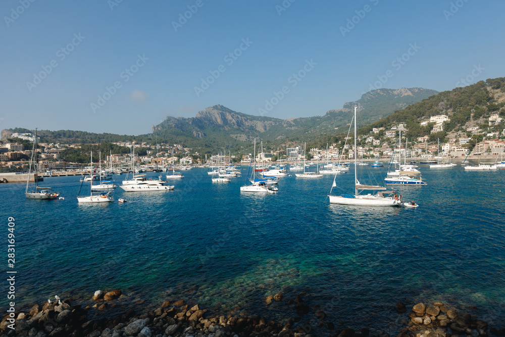 Puerto de Soller Port of Mallorca with boats in balearic island, Spain. Panoramic view of beautiful Port de Soller boats yachts at coast of Mallorca island, Spain