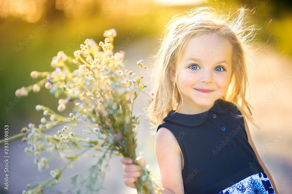 playful cute little girl playing outdoors at sunset, holding a bouquet of wildflowers and smiling, happy childhood playful cute little girl playing outdoors at sunset, holding a bouquet of wildflowers and smiling, happy childhood