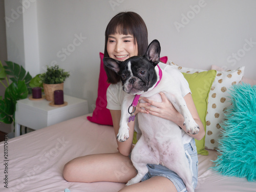 Women hugging dogs on the bed