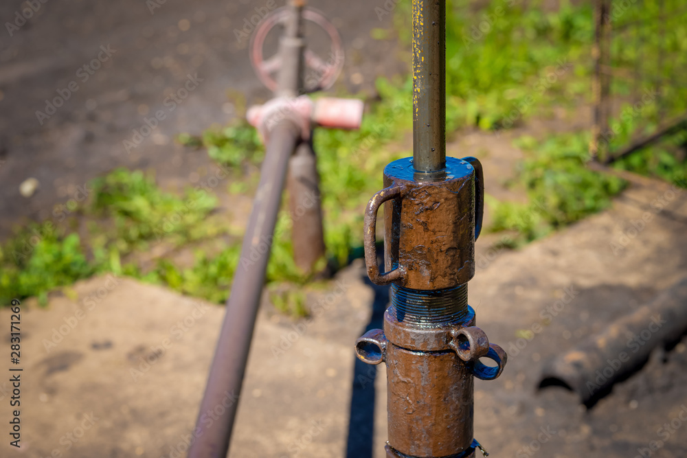 Oil and gas processing plant with pipe line valves. Oil pipeline valves in the oil and gas industry. Valve plug an oil pipeline in the field on a sunny summer day.