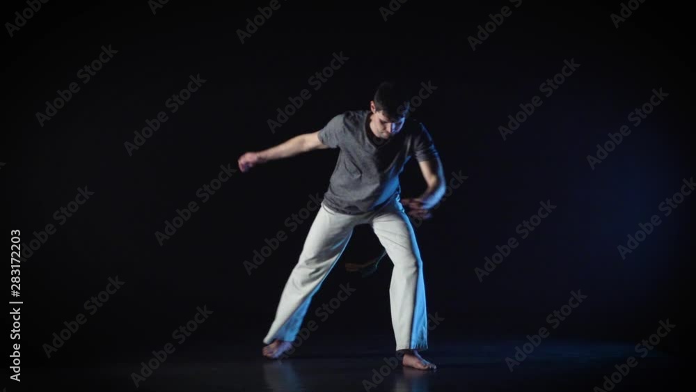 Brunette guy performing incredibly complex of martial art of capoeira. Slow motion. Brunette guy performing incredibly complex of martial art of capoeira. Slow motion.