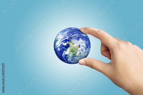 Hand Holding Earth On Blue Gradient Background, Save The World Concept,Elements of this image furnished by NASA