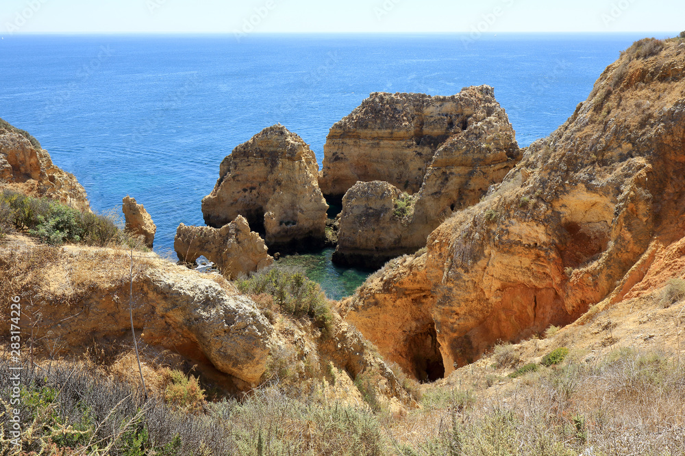 A landscape scene showing the rocky cliffs and jagged pillars at the Ponta Da Piedade headland in Lagos