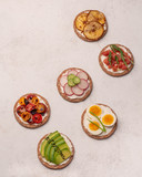 crostini with different toppings on a light background