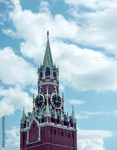 Spasskaya tower of the Moscow Kremlin with a clock-chime against the sky. Moscow, Russia.