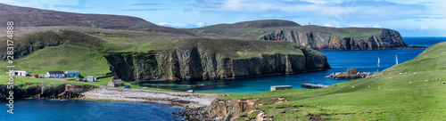 Wide panorama of Fair Isle in Scotland at the sunny day