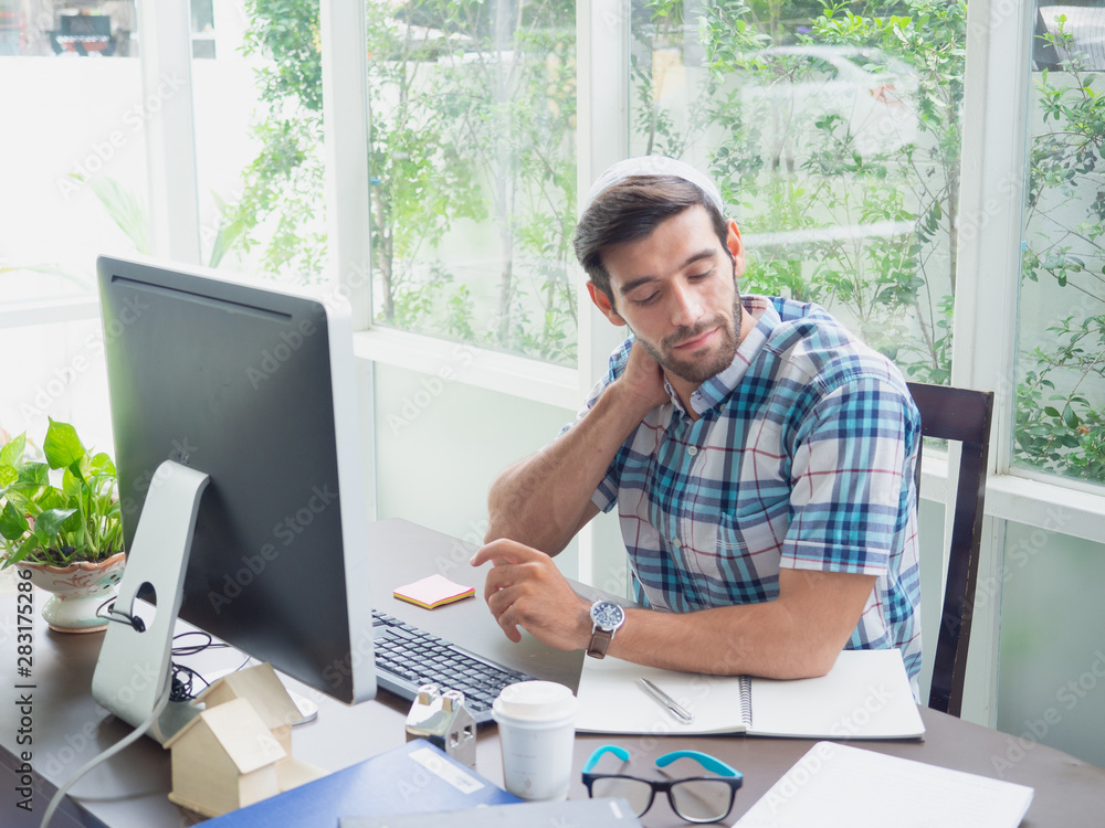 young man working at home and Stretch ,businessman works on his computer to get all his business young man working at home and Stretch ,businessman works on his computer to get all his business